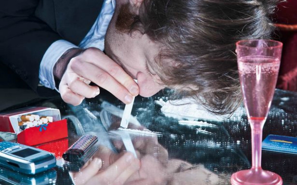 Young-man-sniffing-cocaine